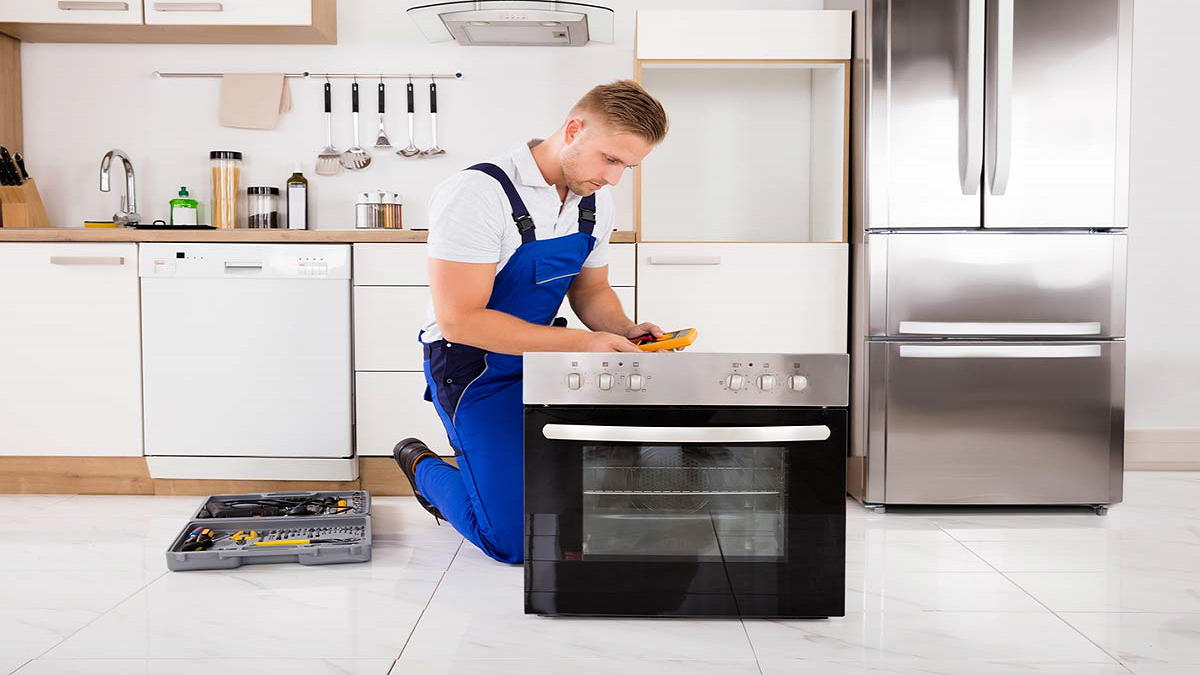 Professional technician providing oven repair services in New Castle, DE, fixing a malfunctioning oven to restore optimal performance